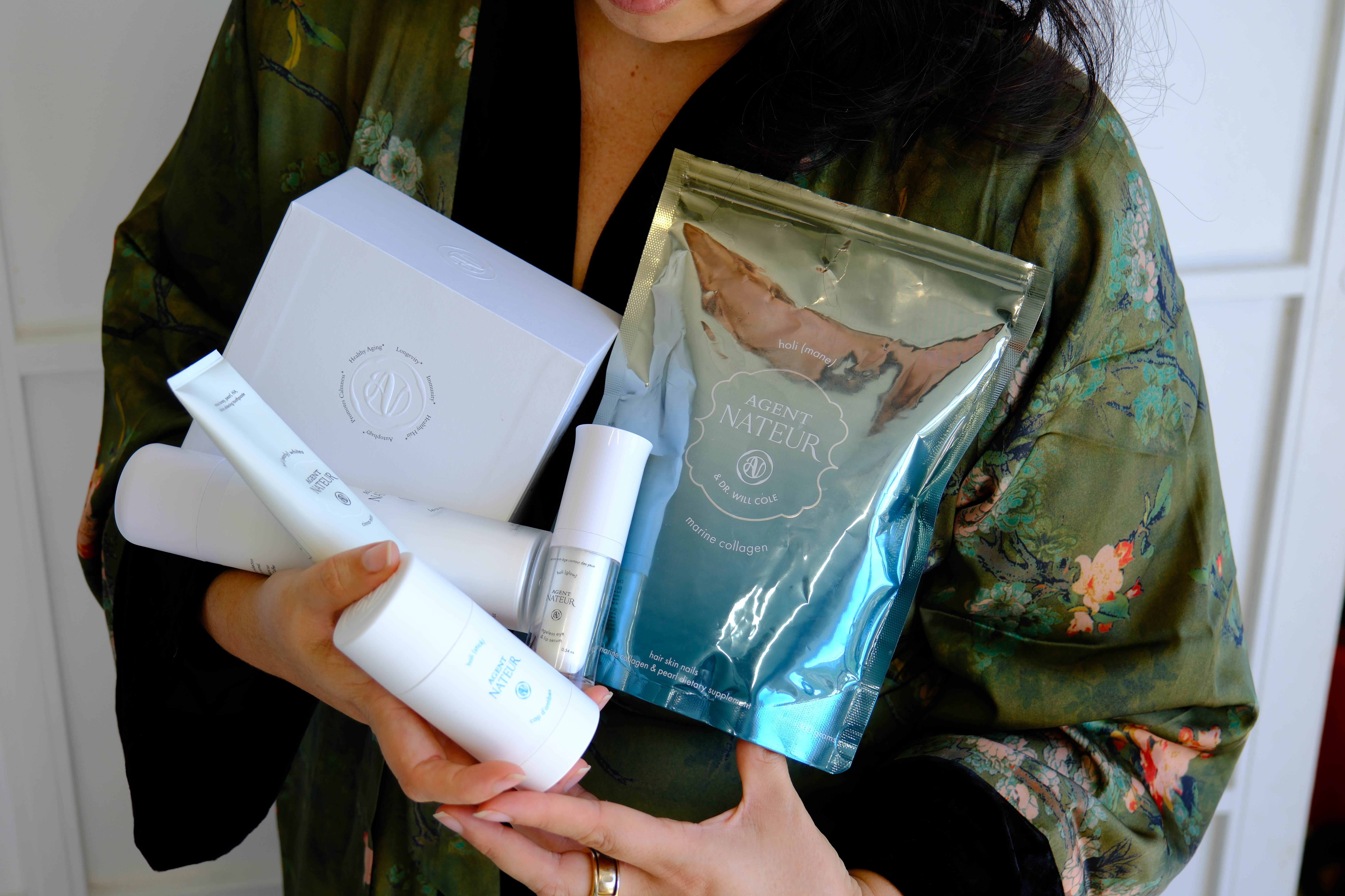 Holding a gifted haul of Agent Nateur clean beauty and wellness products. Agent Nateur promo code SALTYVAGABONDS10 for 10% off at agentnateur.com