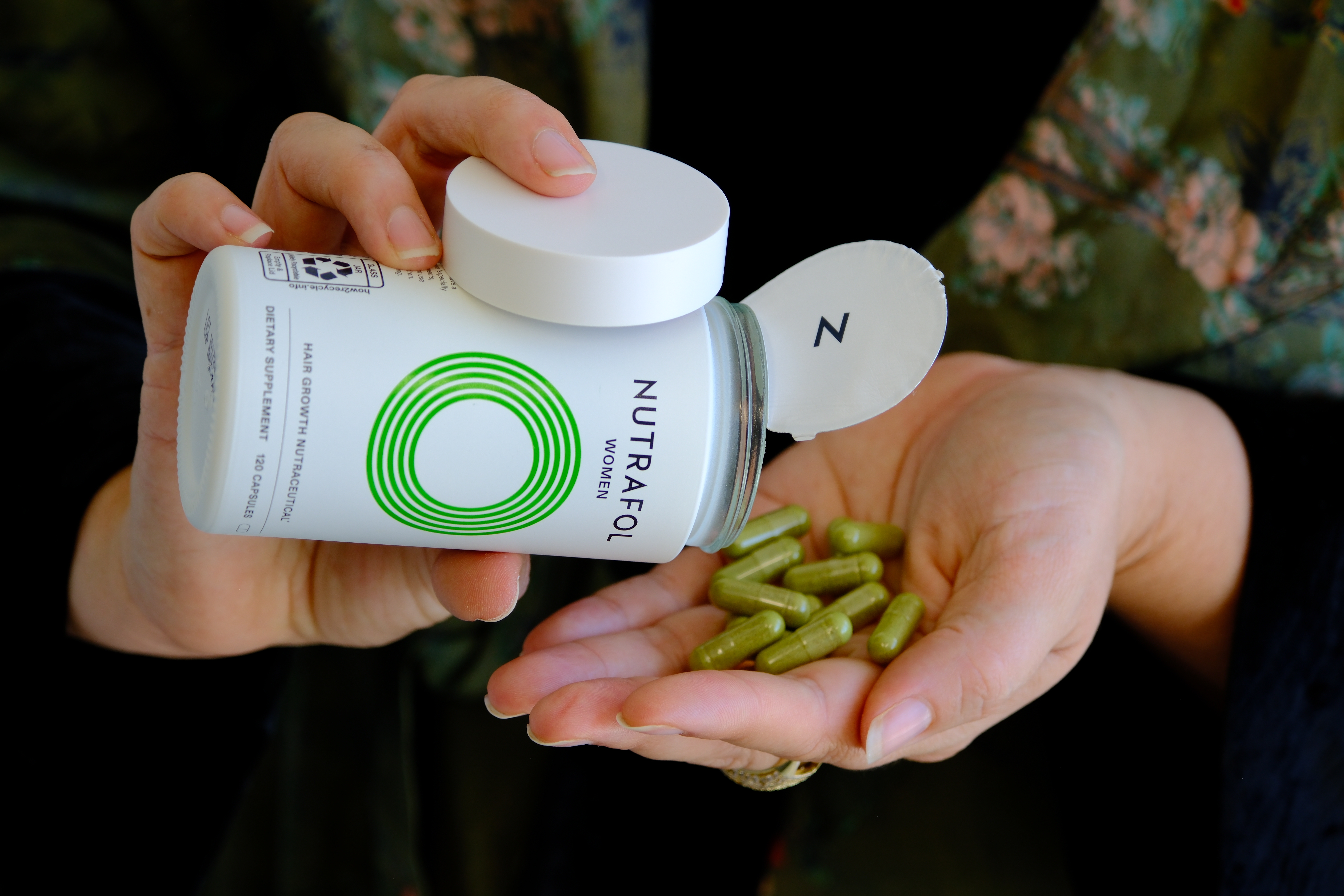 what Nutrafol Women hair growth capsules look like, a 120 capsule jar poured into a hand for a GLP-1 hair shedding review, Nutrafol promo with no code needed for $40 off. Nutrafol promo code No code needed for $40 off a 3 month subscription or $106 off a 6 month, plus a free hair serum ($69 value) at nutrafol.com