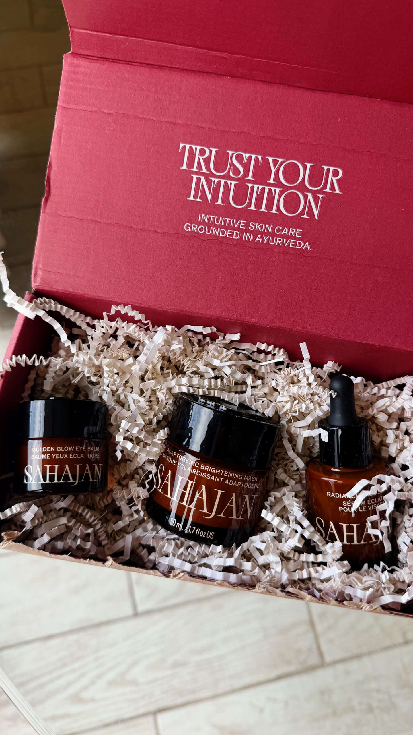 Sahajan Ayurvedic skincare jars in a red Trust Your Intuition gift box. Sahajan promo code SALTYVAGABONDS-15 for 15% off at sahajan.com