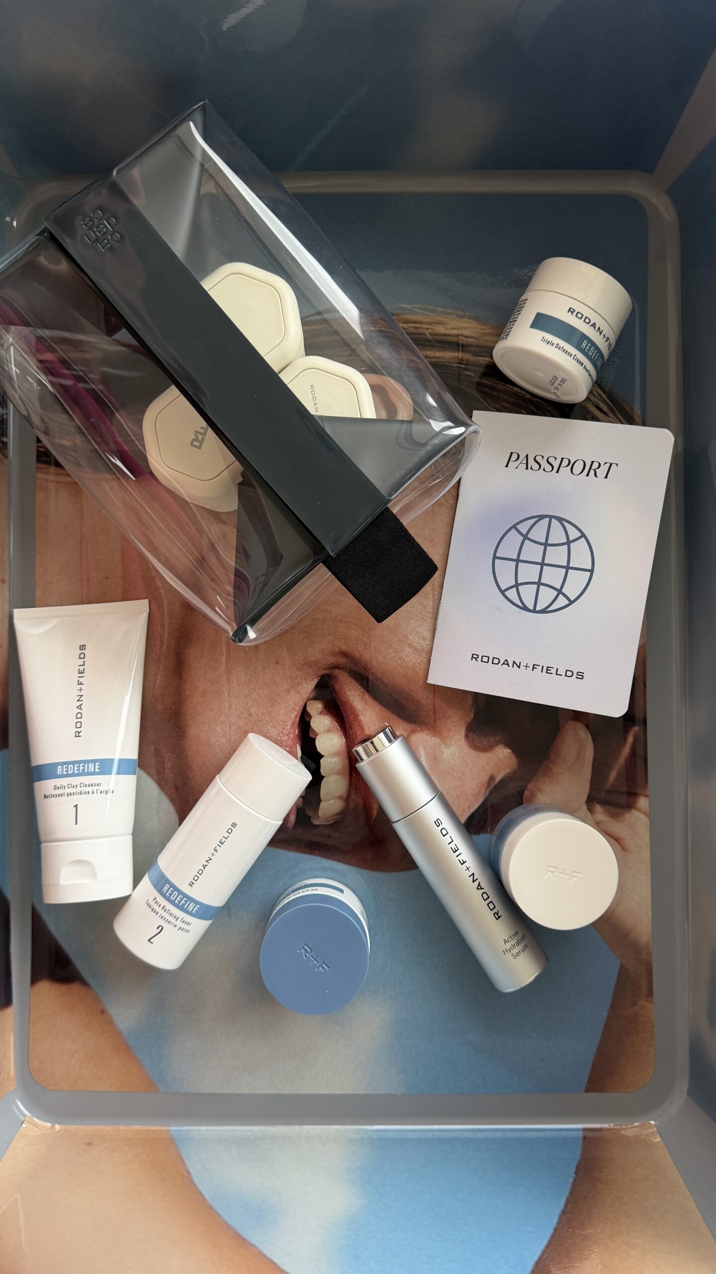 Clear travel makeup bag filled with Rodan + Fields skincare products. Rodan + Fields promo code AMANDAV25 for 25% off at rodanandfields.com